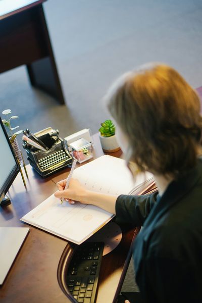 A woman typing at a desk.